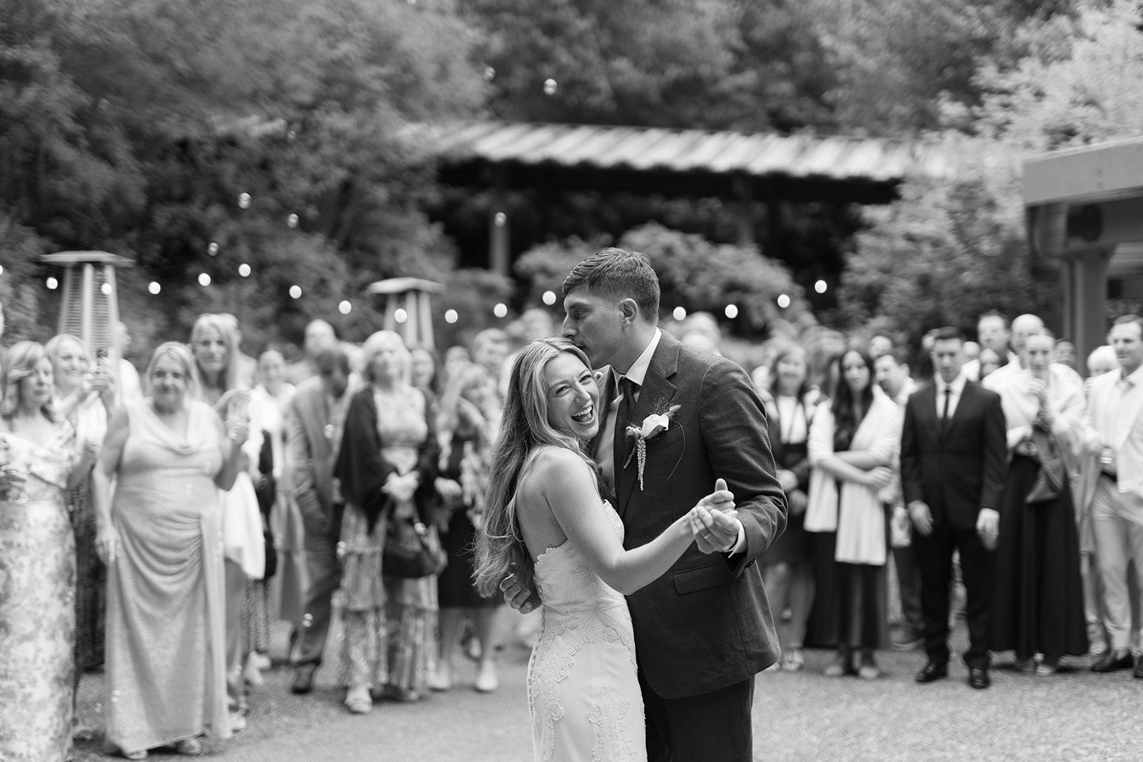 First dance outdoors, guests circled around