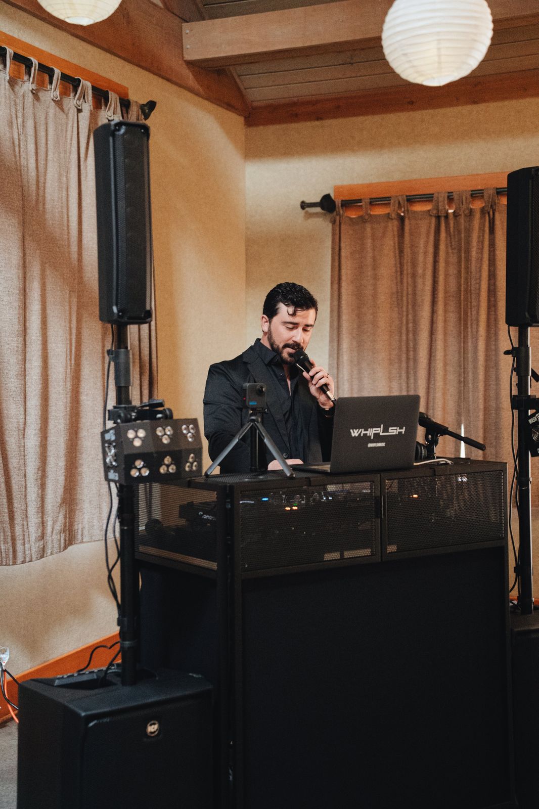 WHIPLSH on the microphone at a professional booth