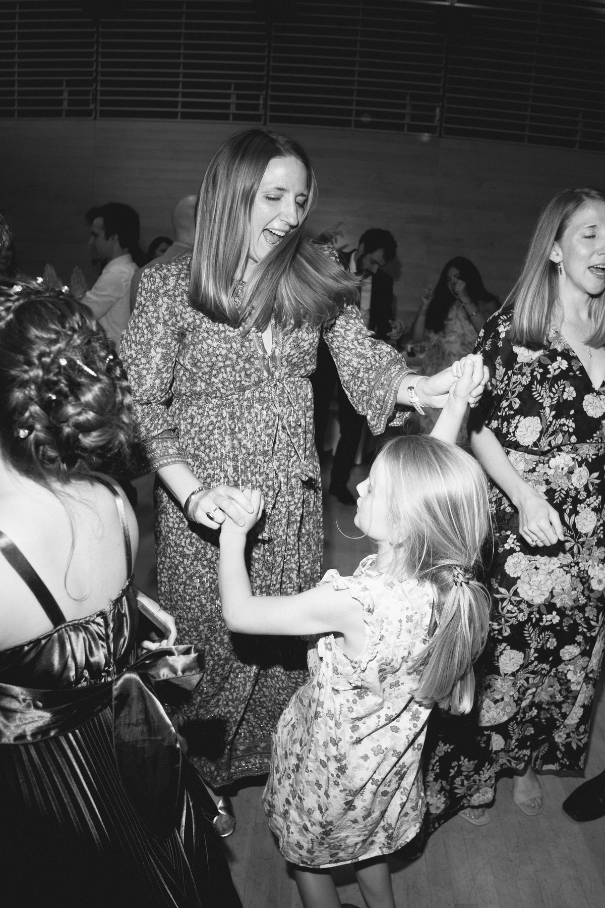 A guest spinning a little girl on the dance floor