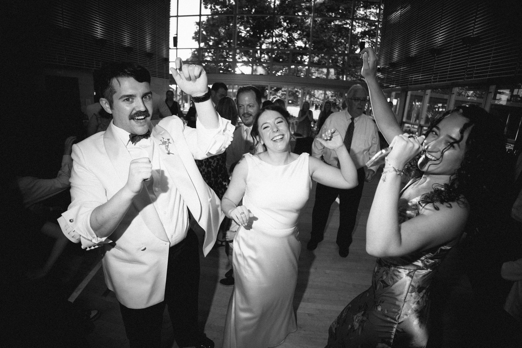 The couple dancing while a guest takes the mic