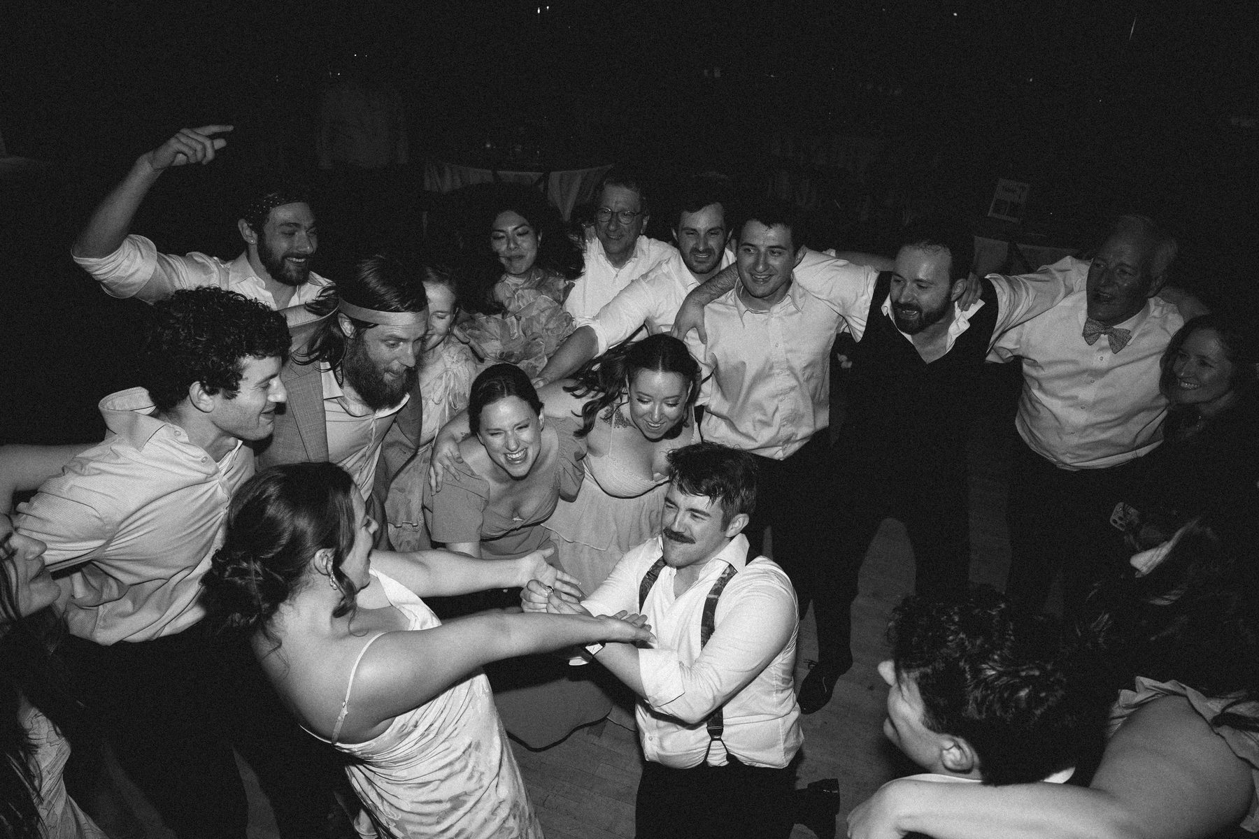 The huddle closing in around the couple