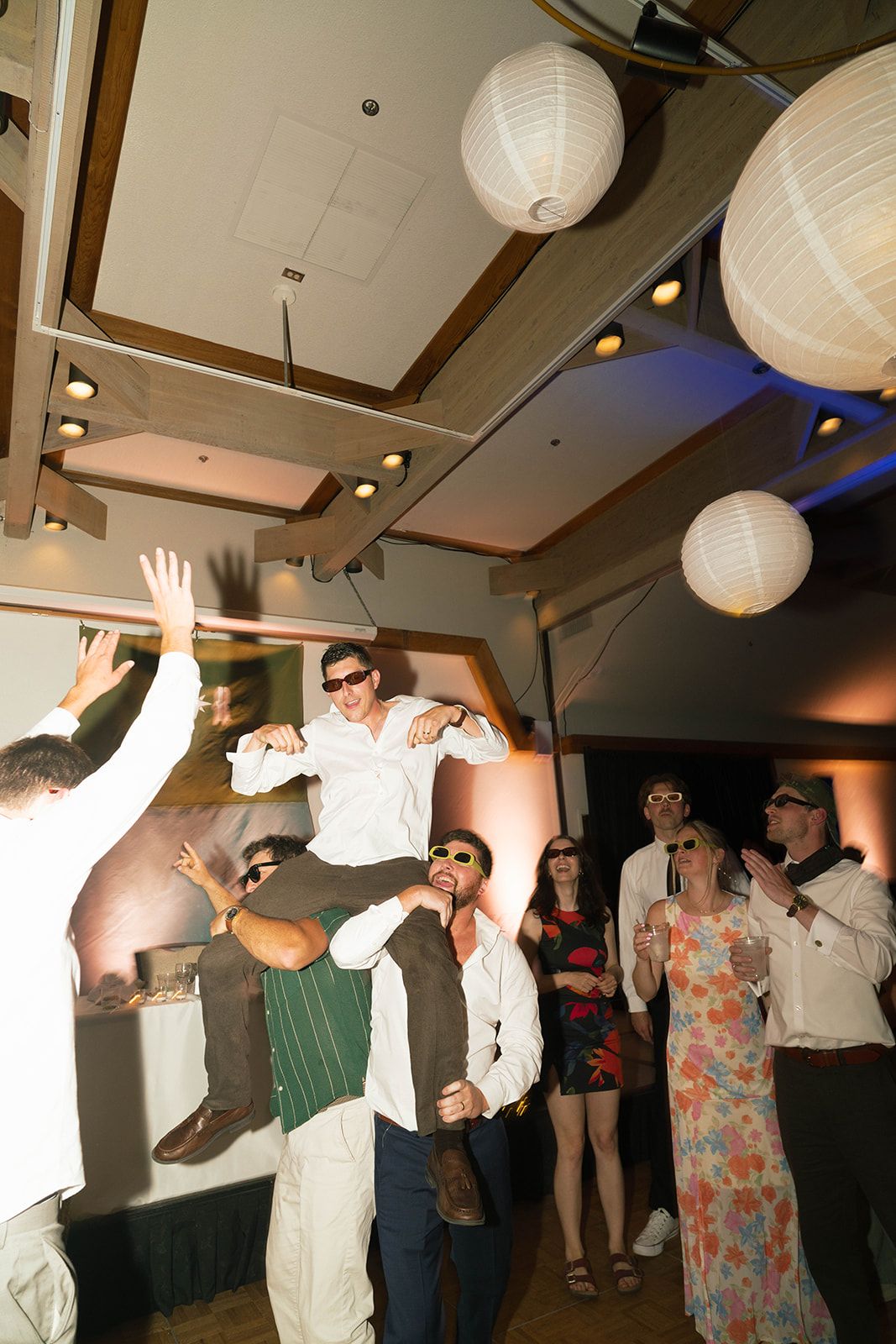 Groom on shoulders as the floor goes off