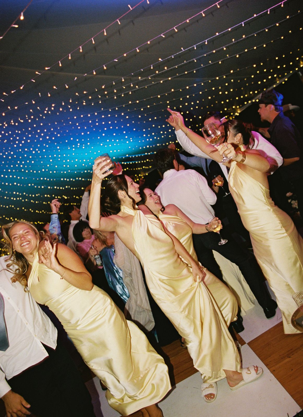 Bridesmaids and the whole room moving under color lights