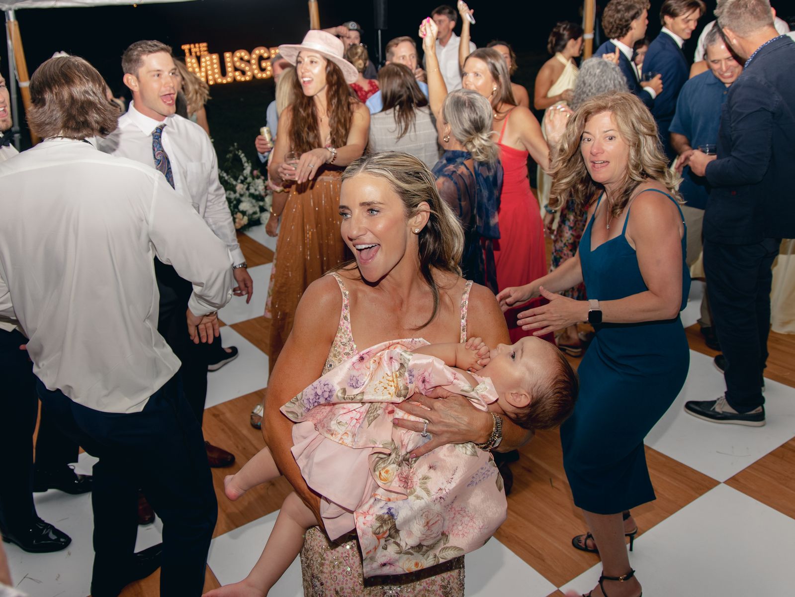 Multigenerational dance floor, baby in arms