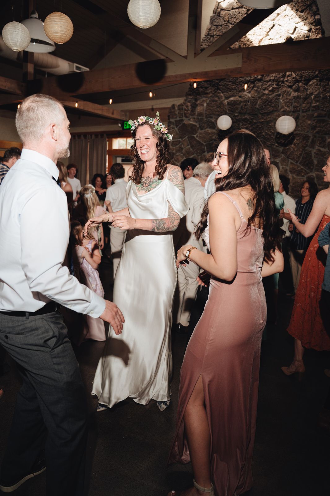 Bride laughing in the middle of her people