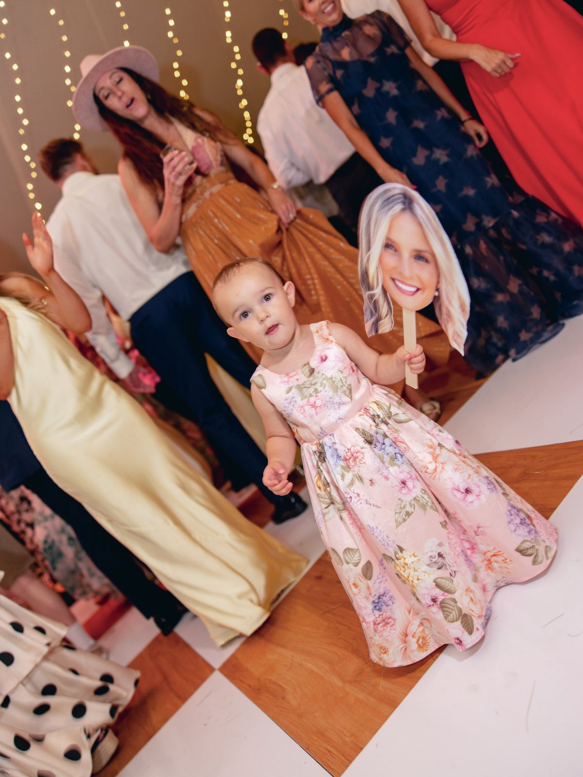Toddler with a face paddle on the floor