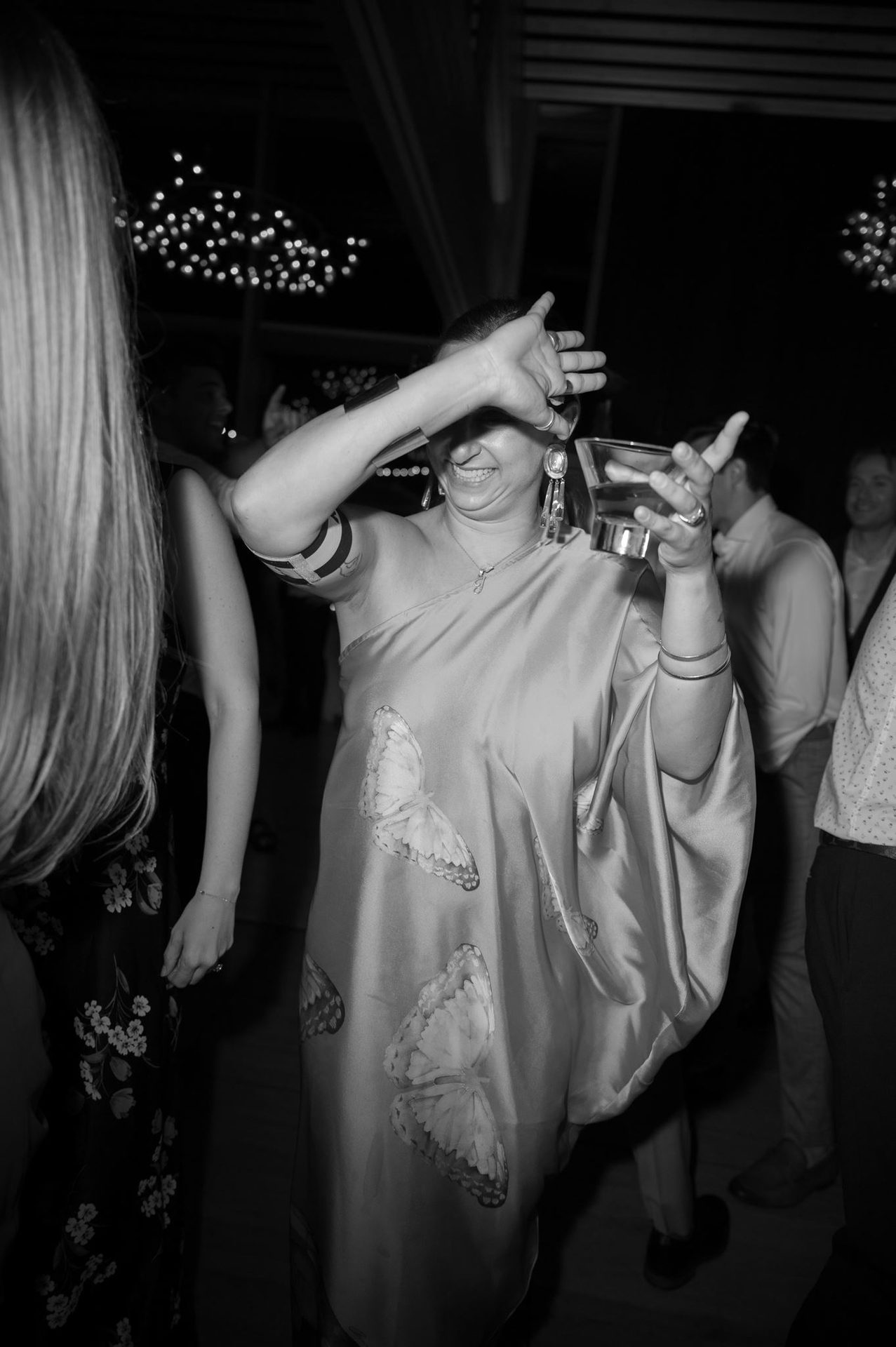 A guest dancing with a drink in hand