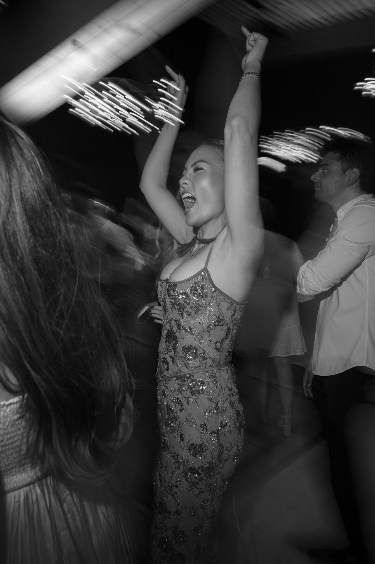 Motion blur, hands up, late-night energy