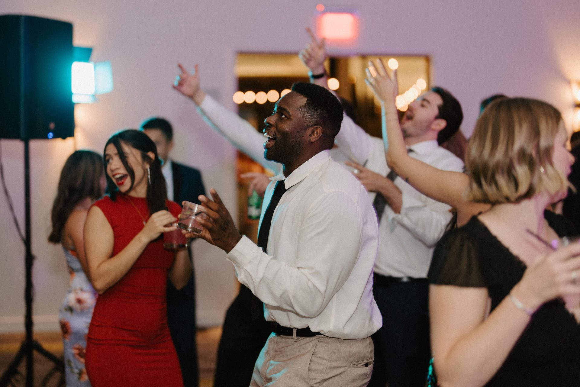 Wedding guests cheering on a packed dance floor
